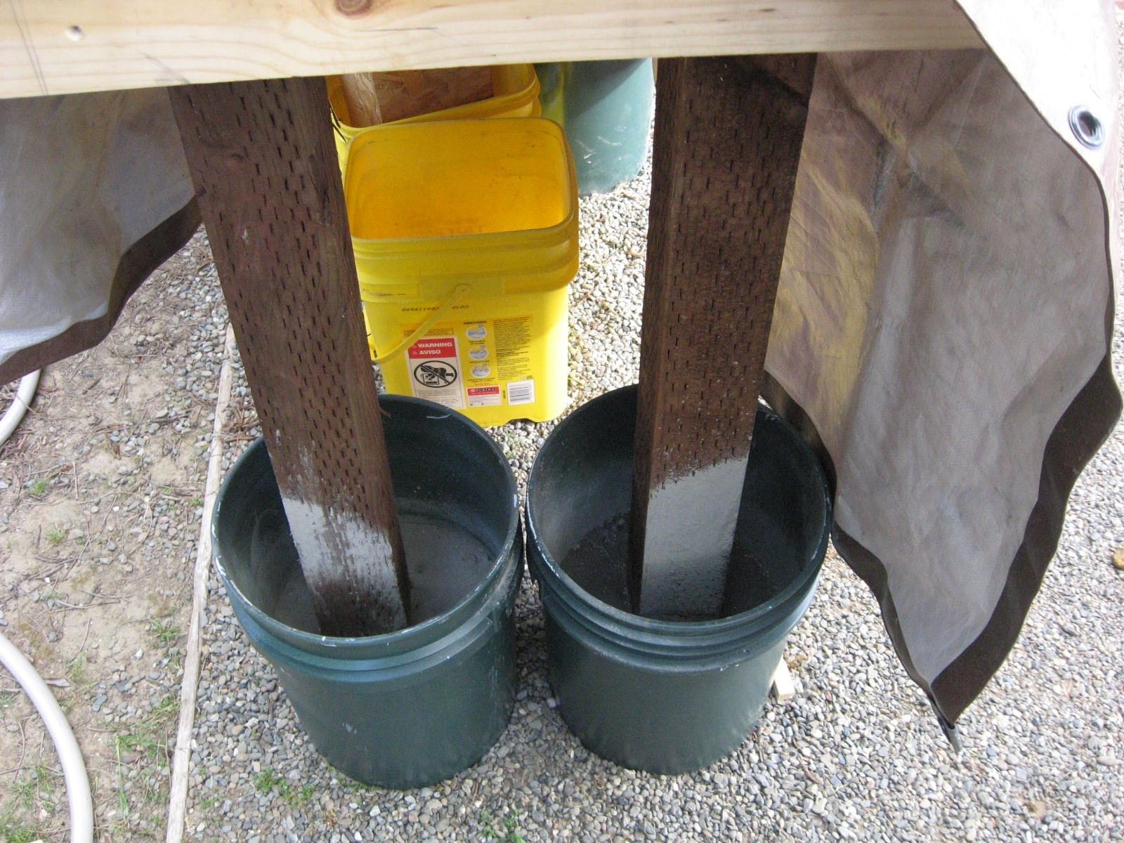 I used buckets to support the 4 x 4 posts for the tables.  I filled the buckets with posthole cement